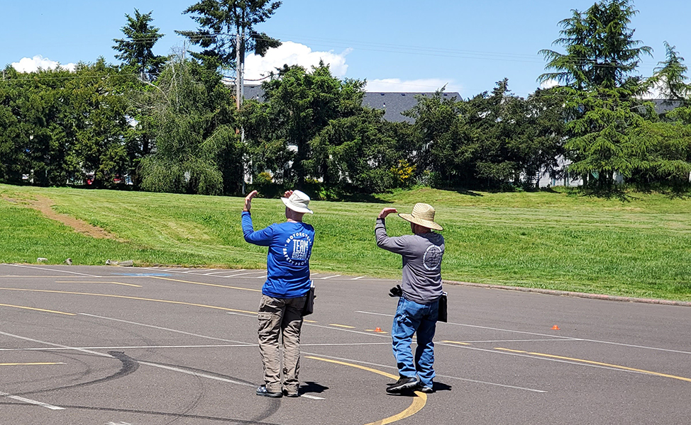 Two team oregon instructors making hand signals while teaching