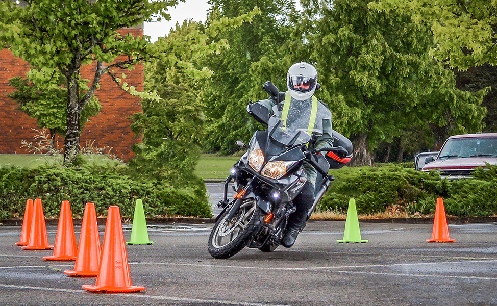 Rider cornering around cones in a parking lot