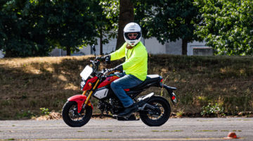 Motorcyclist wearing helmet in parking lot