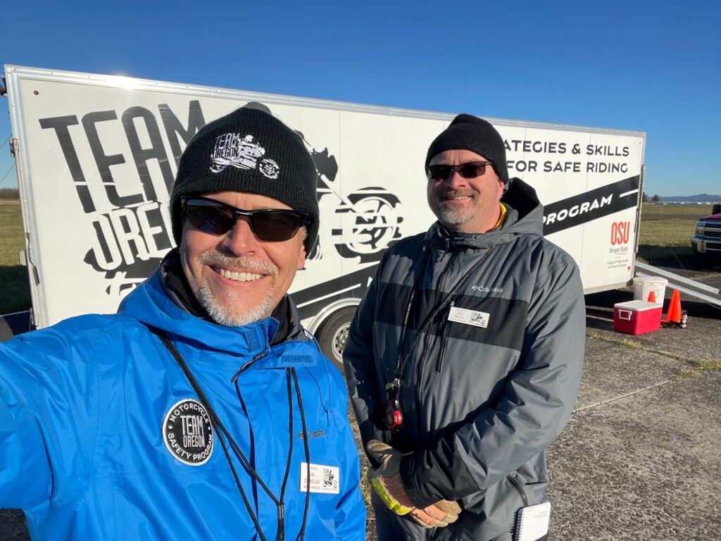 Team Oregon staff with white trailer in background