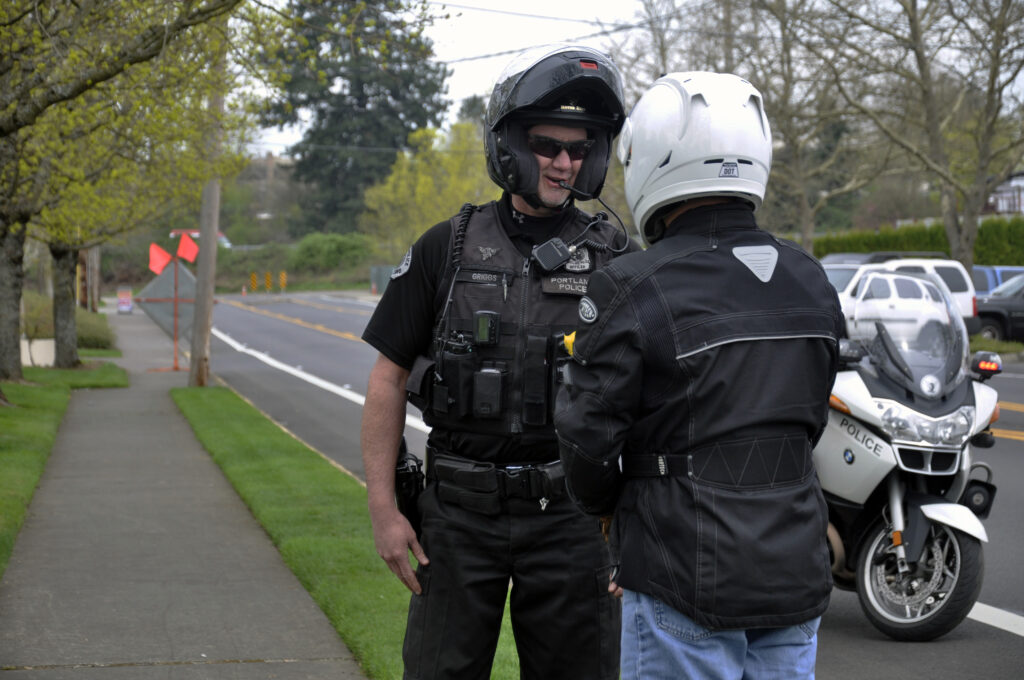 Police officer talking to motorcycle rider