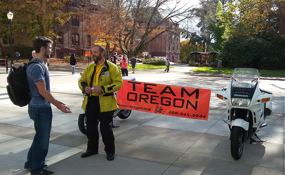 Man taking to OSU student about Team Oregon on campus