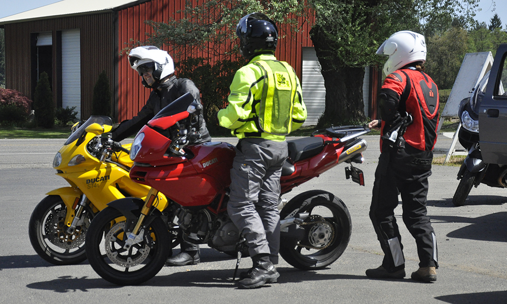 Riders gearing up and preparing to depart on motorcycles